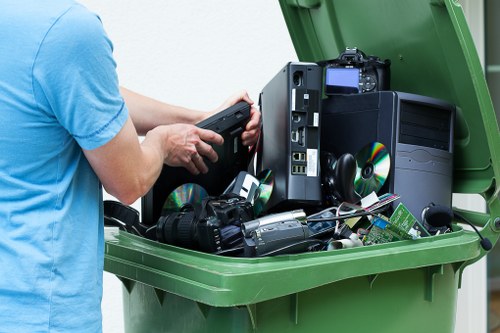 Inspector examining commercial rubbish containers during investigation